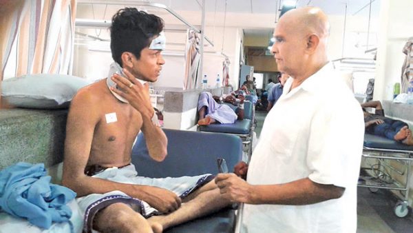 Northern Province Governor Reginald Cooray visiting injured Sinhala student in hospital ~ via dailynews.lk 