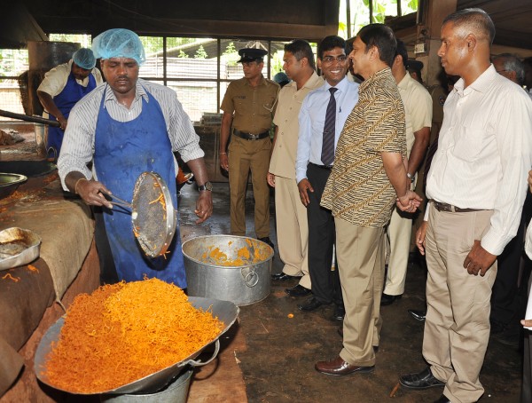 Central Bank Governor Ajith Nivard Cabraal observes the mixture production process at Alpha Mixture Industries