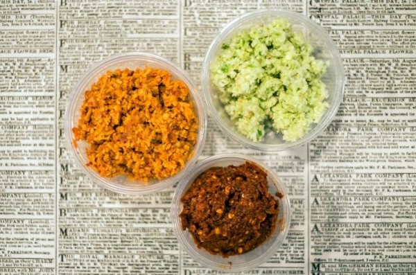 Counterclockwise from top right: minchi sambol, a beautifully bright paste of fresh grated coconut and lime; pol sambol, a tumble of red onion and tomato; and racked by chile, the ruthless conflagration that is lunu sambol.