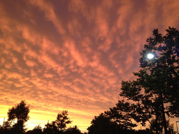 The sky with golden clouds  and the earth down below felt like in dome of orange flood lights